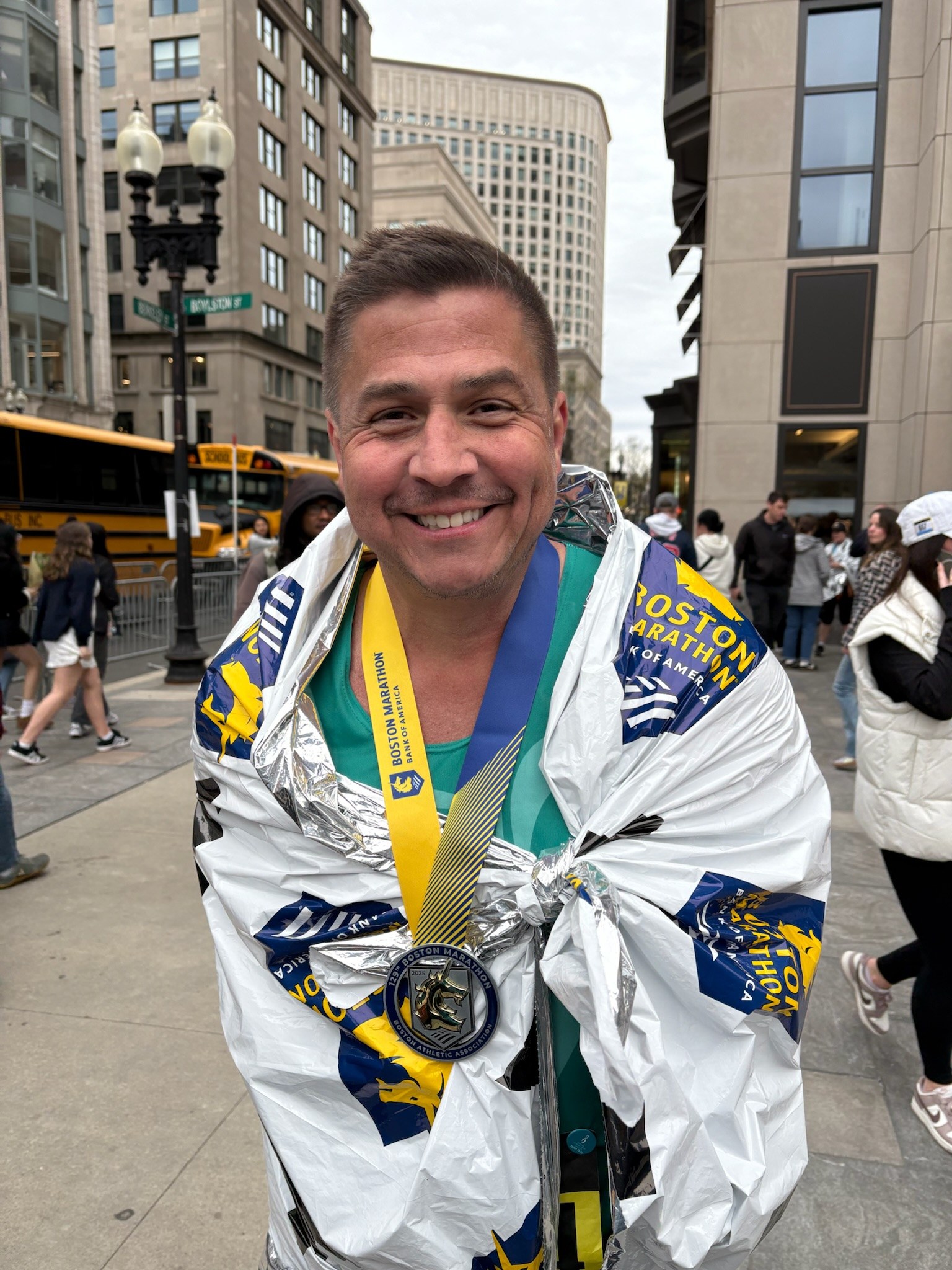 Juan smiling with his medal after the 2025 Boston Marathon
